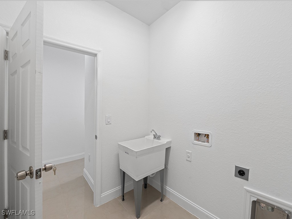 902 Williams Avenue Lehigh Acres, FL 33972 - Photo 25 of 30 a bathroom with a sink and a mirror