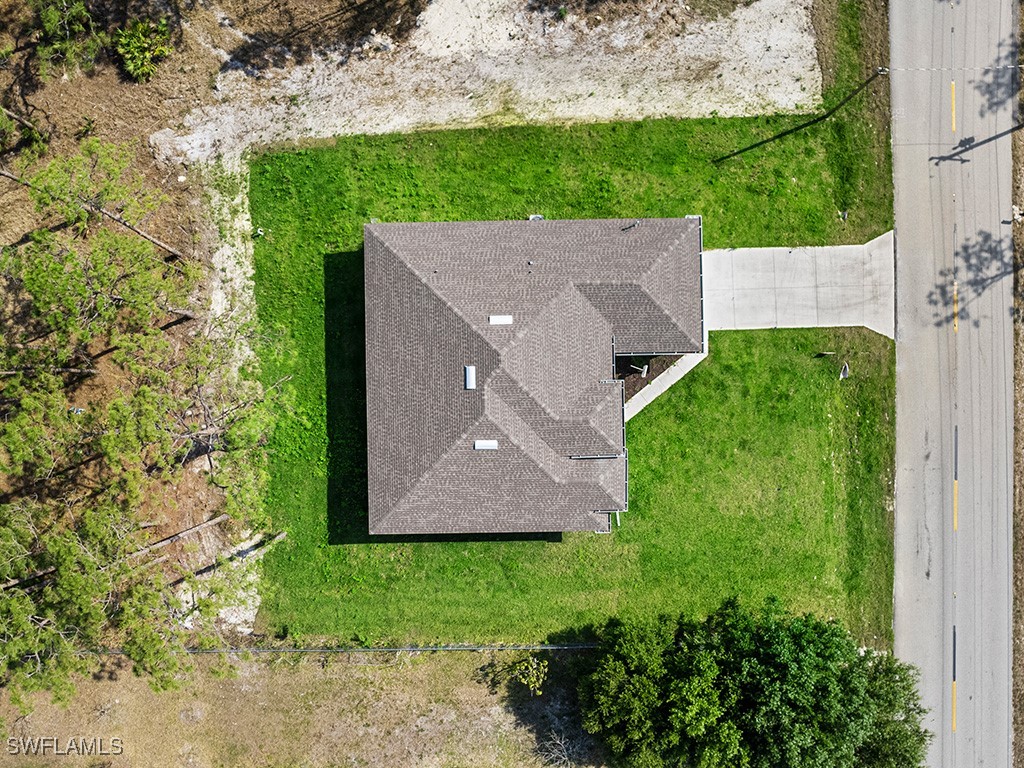 902 Williams Avenue Lehigh Acres, FL 33972 - Photo 4 of 30 an aerial view of a house with a yard and trees