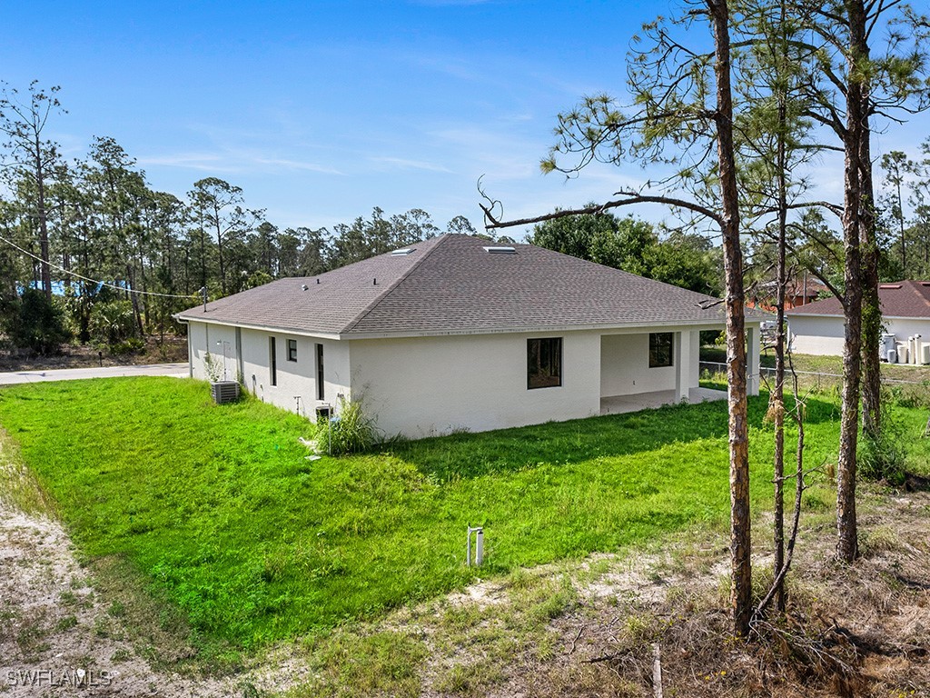 902 Williams Avenue Lehigh Acres, FL 33972 - Photo 5 of 30 a aerial view of a house next to a yard