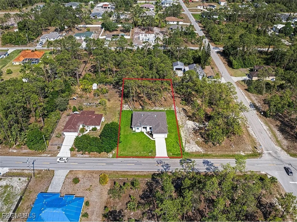 902 Williams Avenue Lehigh Acres, FL 33972 - Photo 6 of 30 an aerial view of a residential houses with yard