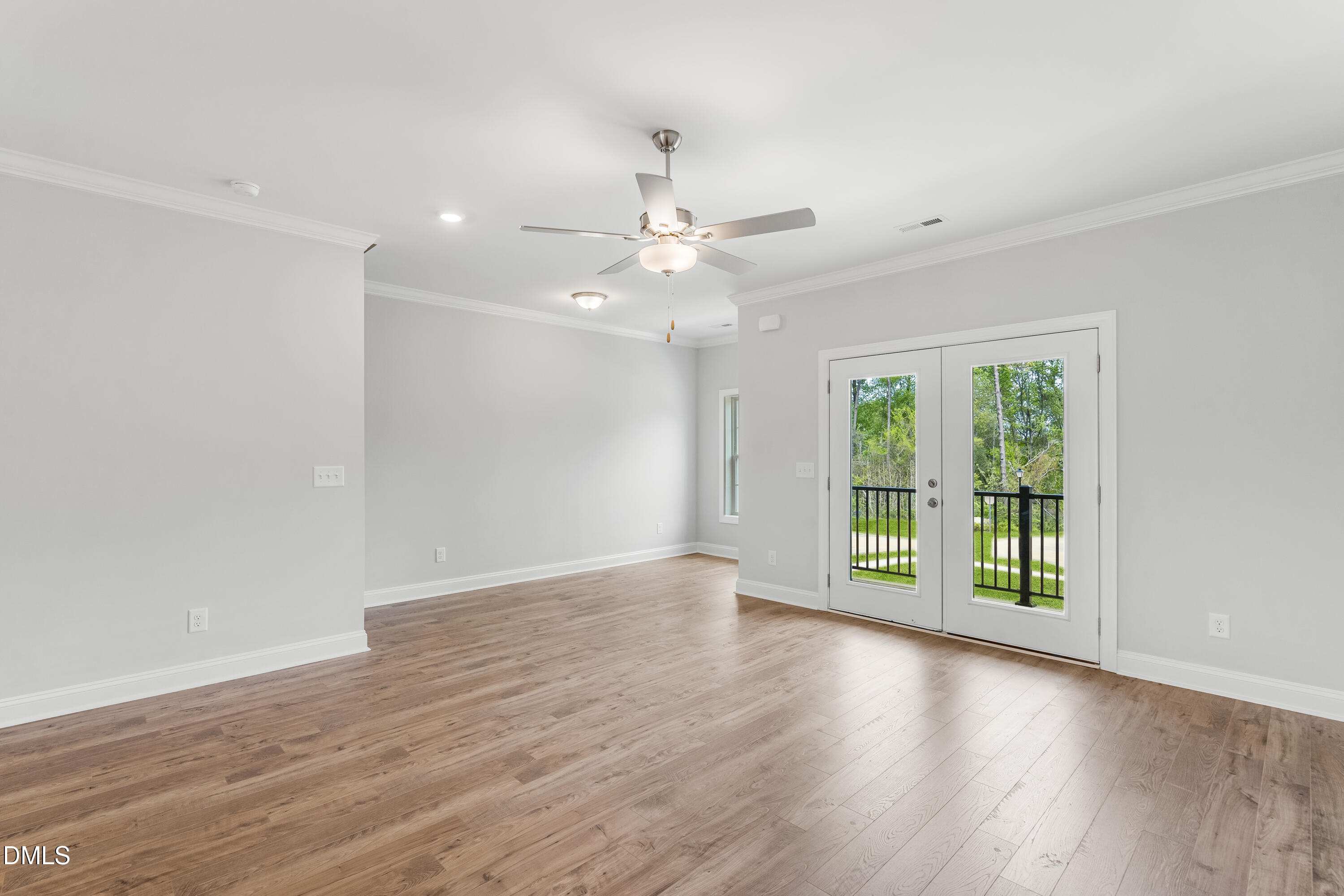 519 Forestville Road Wake Forest, NC 27587 - Photo 13 of 38 a view of an empty room with wooden floor and a window