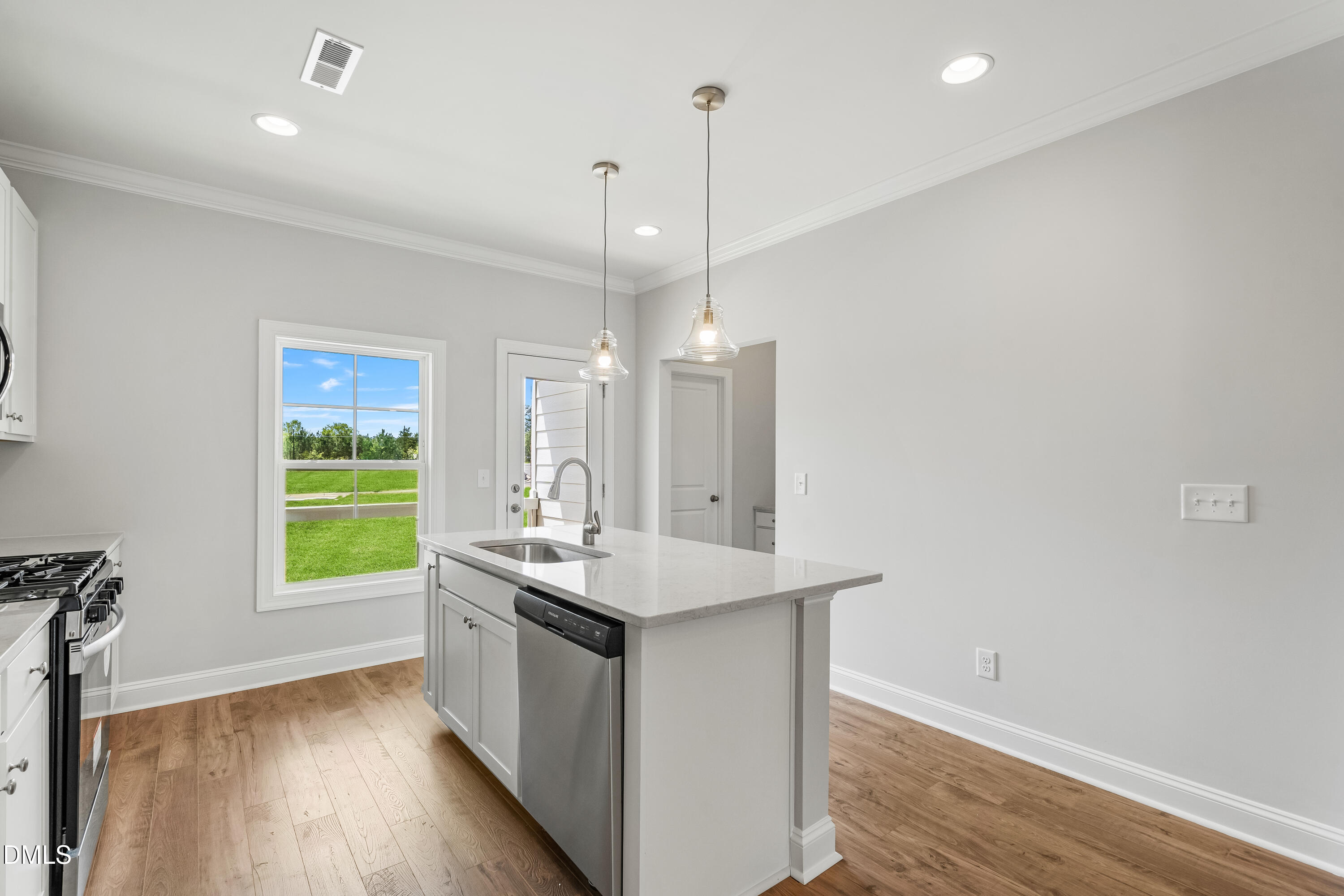 519 Forestville Road Wake Forest, NC 27587 - Photo 21 of 38 a kitchen with kitchen island a sink appliances and a window