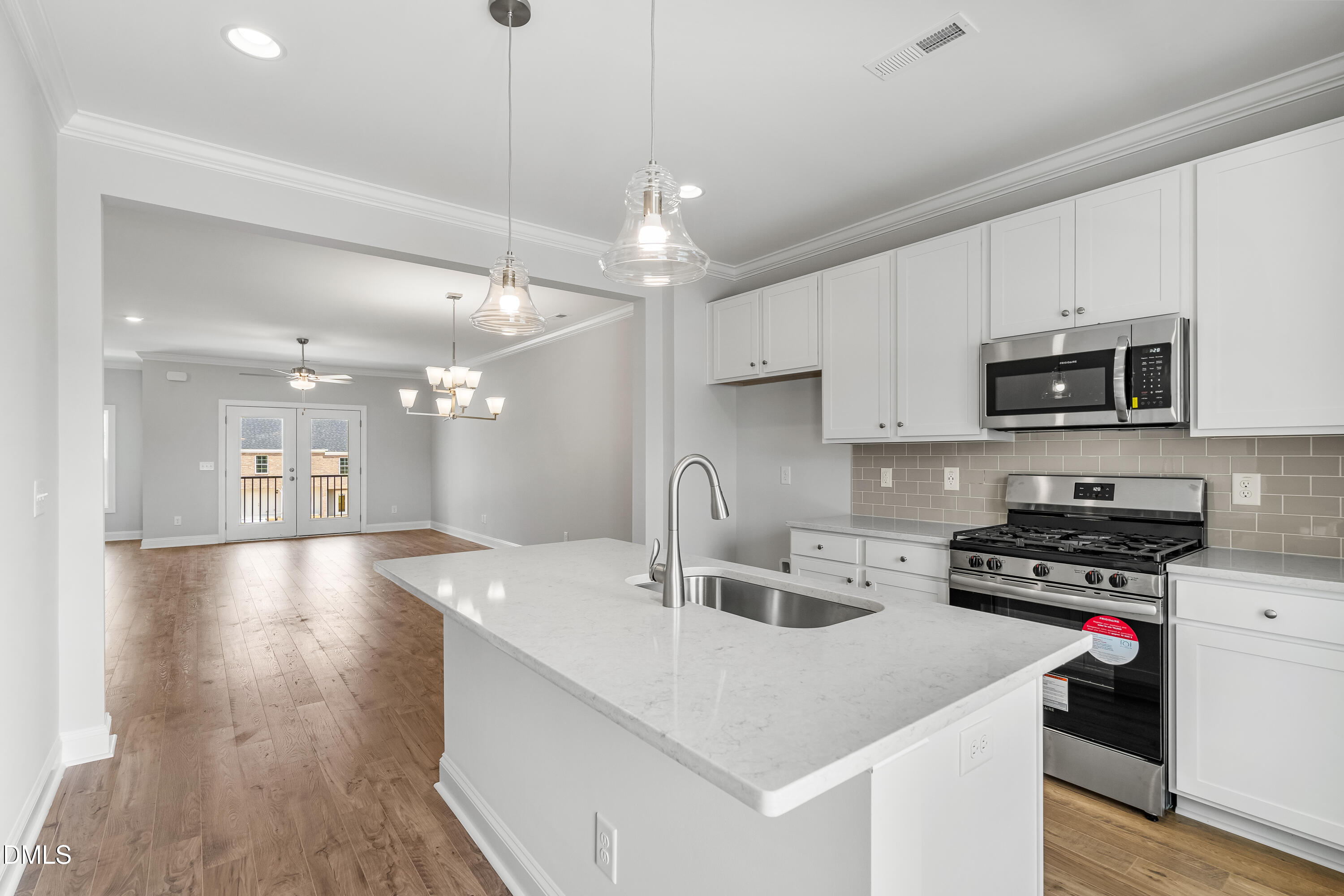 519 Forestville Road Wake Forest, NC 27587 - Photo 23 of 38 a kitchen with kitchen island a sink appliances and cabinets