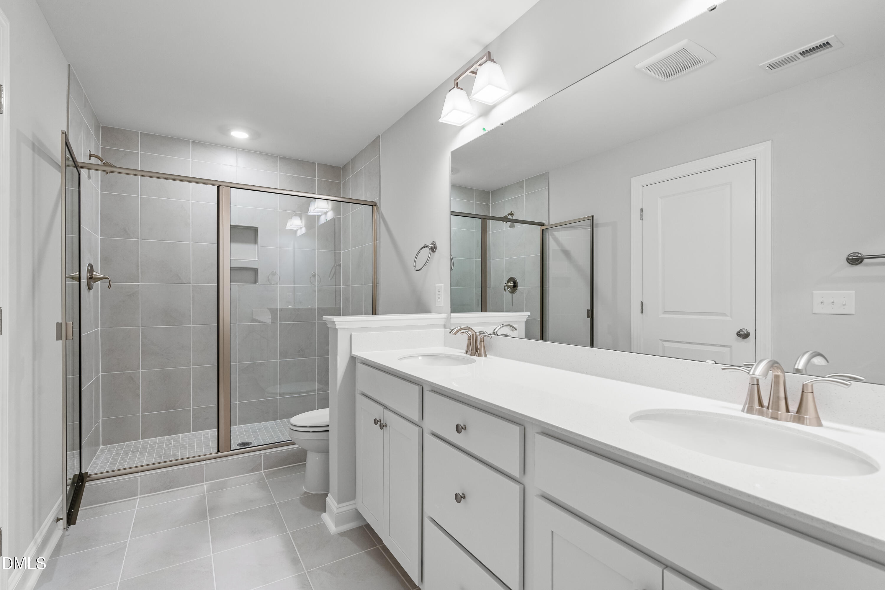 519 Forestville Road Wake Forest, NC 27587 - Photo 32 of 38 a spacious bathroom with a shower sink mirror and toilet