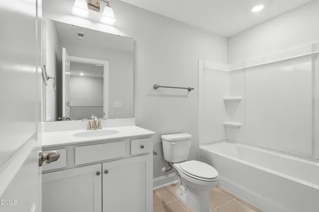 a bathroom with a sink toilet vanity and tub