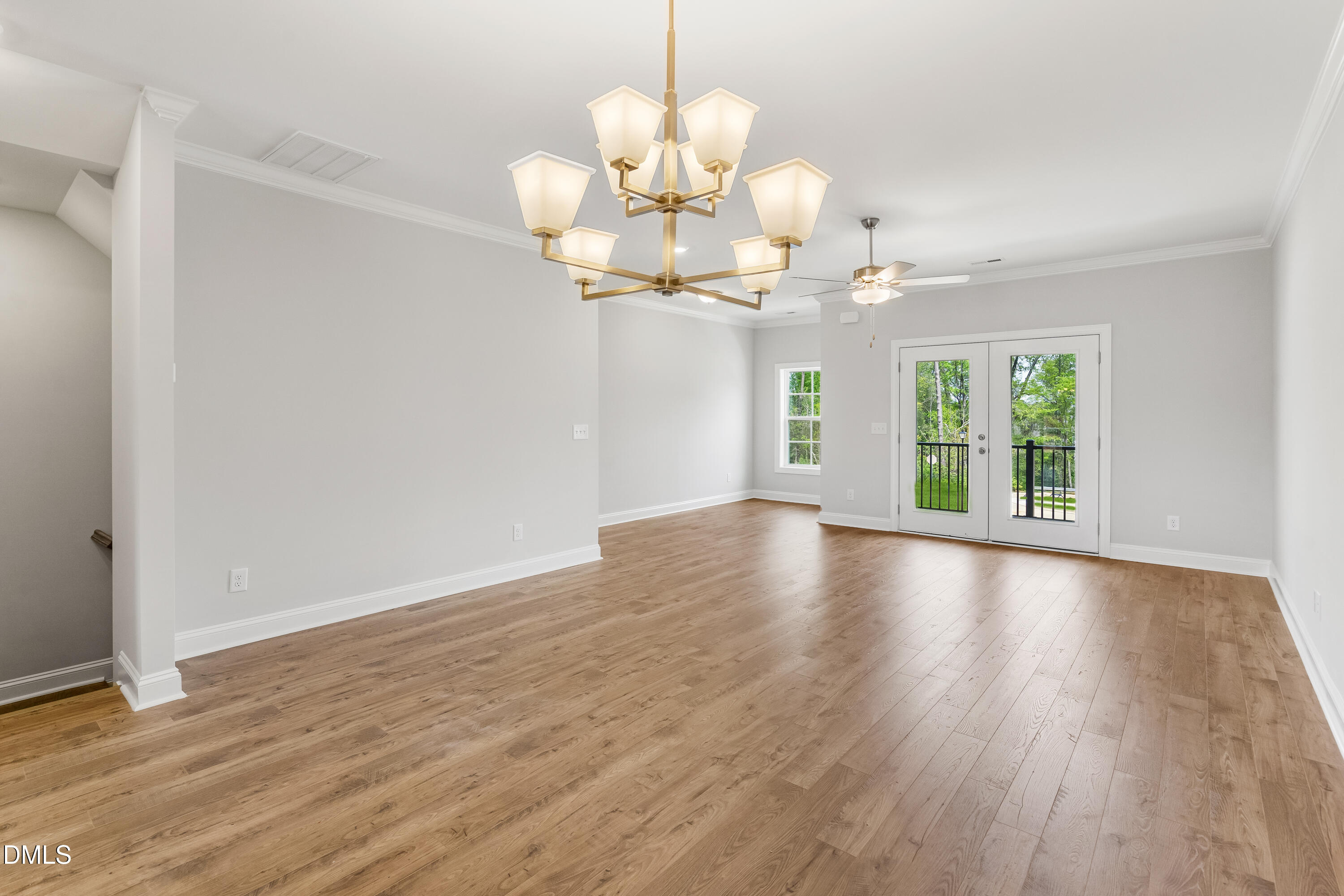 519 Forestville Road Wake Forest, NC 27587 - Photo 8 of 38 a view of an empty room with wooden floor and a window