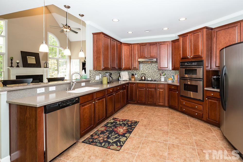 5020 Big Creek Road Raleigh, NC 27613 - Photo 13 of 25 a kitchen with stainless steel appliances granite countertop a sink counter space cabinets and a large window