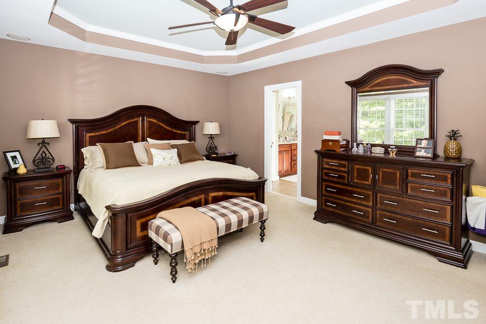 5020 Big Creek Road Raleigh, NC 27613 - Photo 17 of 25 a bedroom with a bed and a dresser