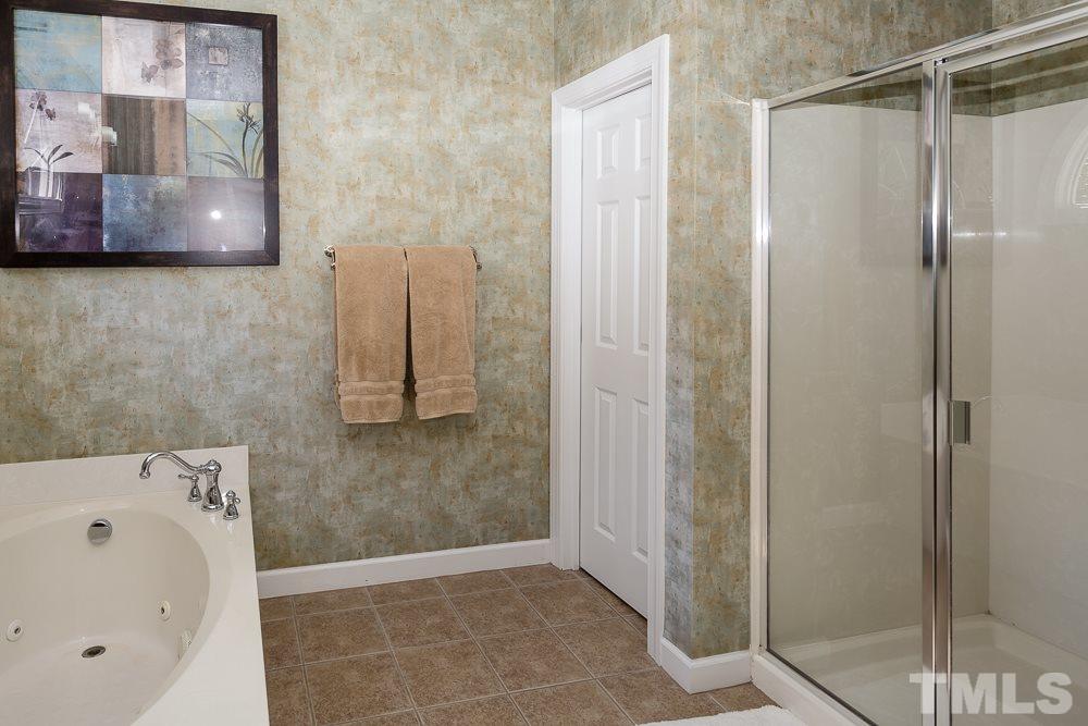 5020 Big Creek Road Raleigh, NC 27613 - Photo 19 of 25 a bathroom with a bathtub and a shower
