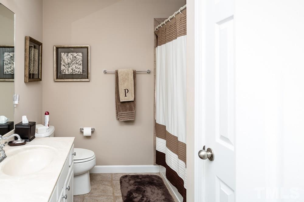 5020 Big Creek Road Raleigh, NC 27613 - Photo 23 of 25 a bathroom with a sink toilet and shower