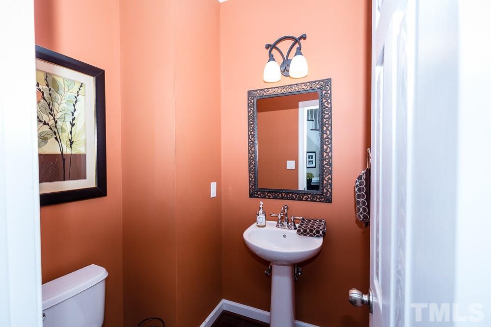 5020 Big Creek Road Raleigh, NC 27613 - Photo 5 of 25 a bathroom with a sink and a mirror