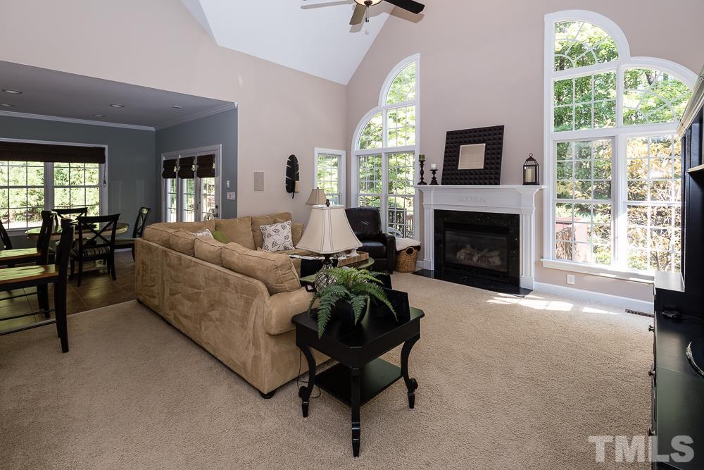 5020 Big Creek Road Raleigh, NC 27613 - Photo 8 of 25 a living room with furniture a large window and a fireplace