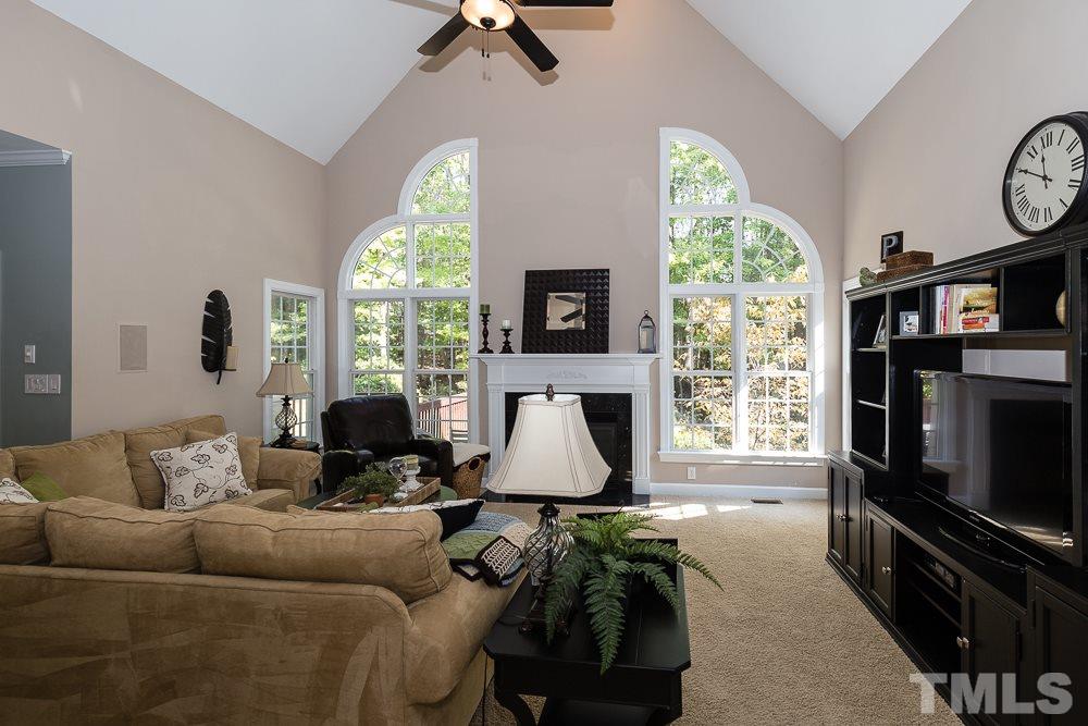 5020 Big Creek Road Raleigh, NC 27613 - Photo 9 of 25 a living room with furniture a window and a flat screen tv