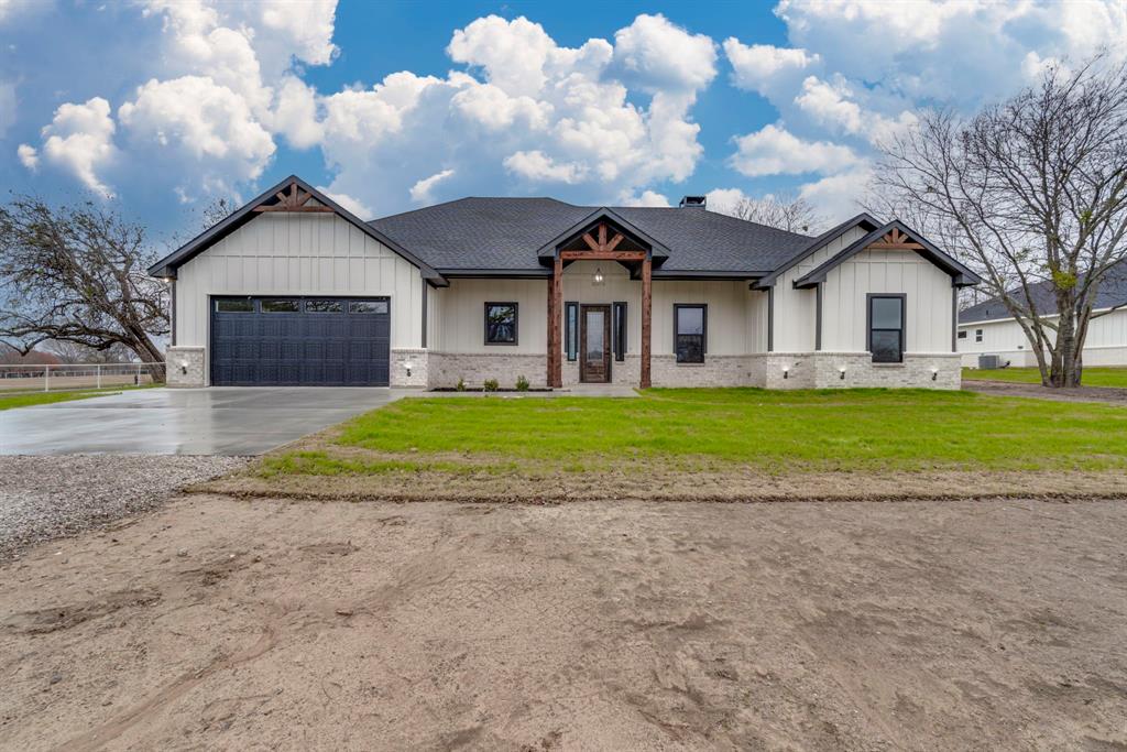 268 Stacks Road Ennis, TX 75119 - Photo 1 of 1 a front view of a house with a yard and garage