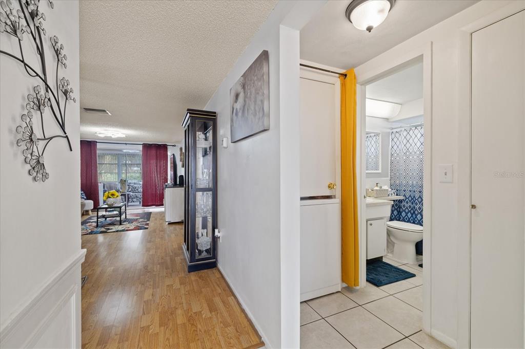 4231 Richmere Drive, Unit 3D New Port Richey, FL 34652 - Photo 17 of 31 a view of hallway with livingroom and wooden floor