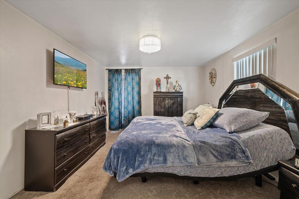 4231 Richmere Drive, Unit 3D New Port Richey, FL 34652 - Photo 23 of 31 a bedroom with a bed and dresser