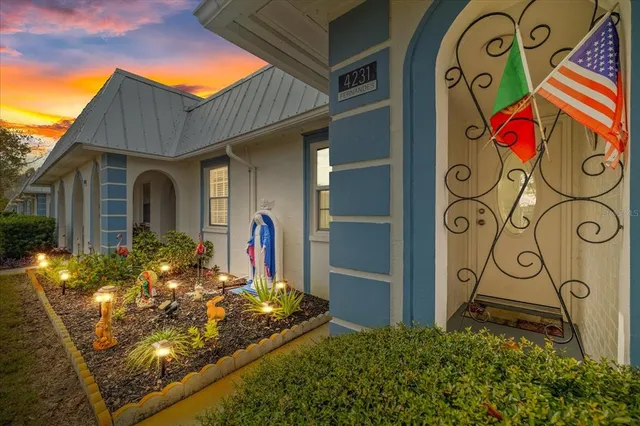 a view of a brick house with potted plants