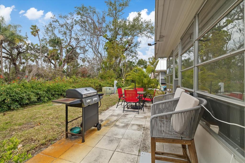 4231 Richmere Drive, Unit 3D New Port Richey, FL 34652 - Photo 7 of 31 a view of a patio with a table chairs and a potted plant