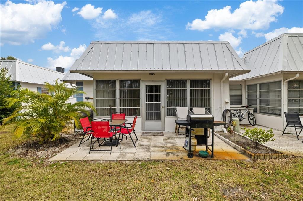 4231 Richmere Drive, Unit 3D New Port Richey, FL 34652 - Photo 8 of 31 a view of a dinning tables and chairs in patio in front of a house