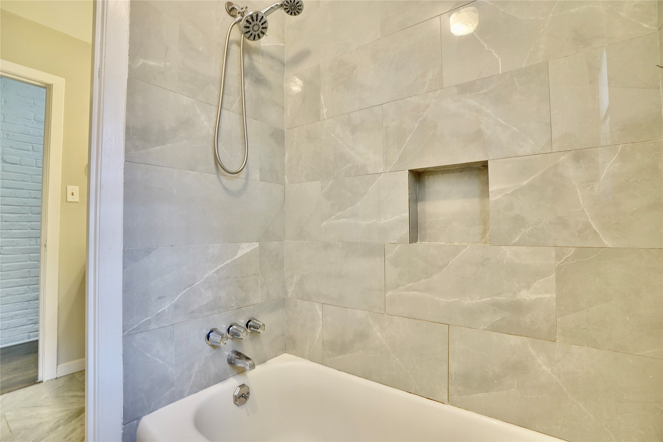 4550 Spellman Road Houston, TX 77035 - Photo 20 of 27 a bathroom with a shower and a bathtub