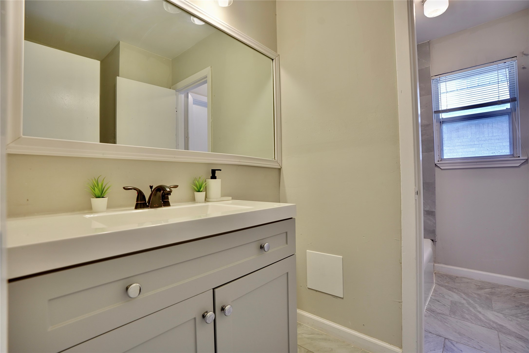 4550 Spellman Road Houston, TX 77035 - Photo 21 of 27 a bathroom with a sink and a mirror