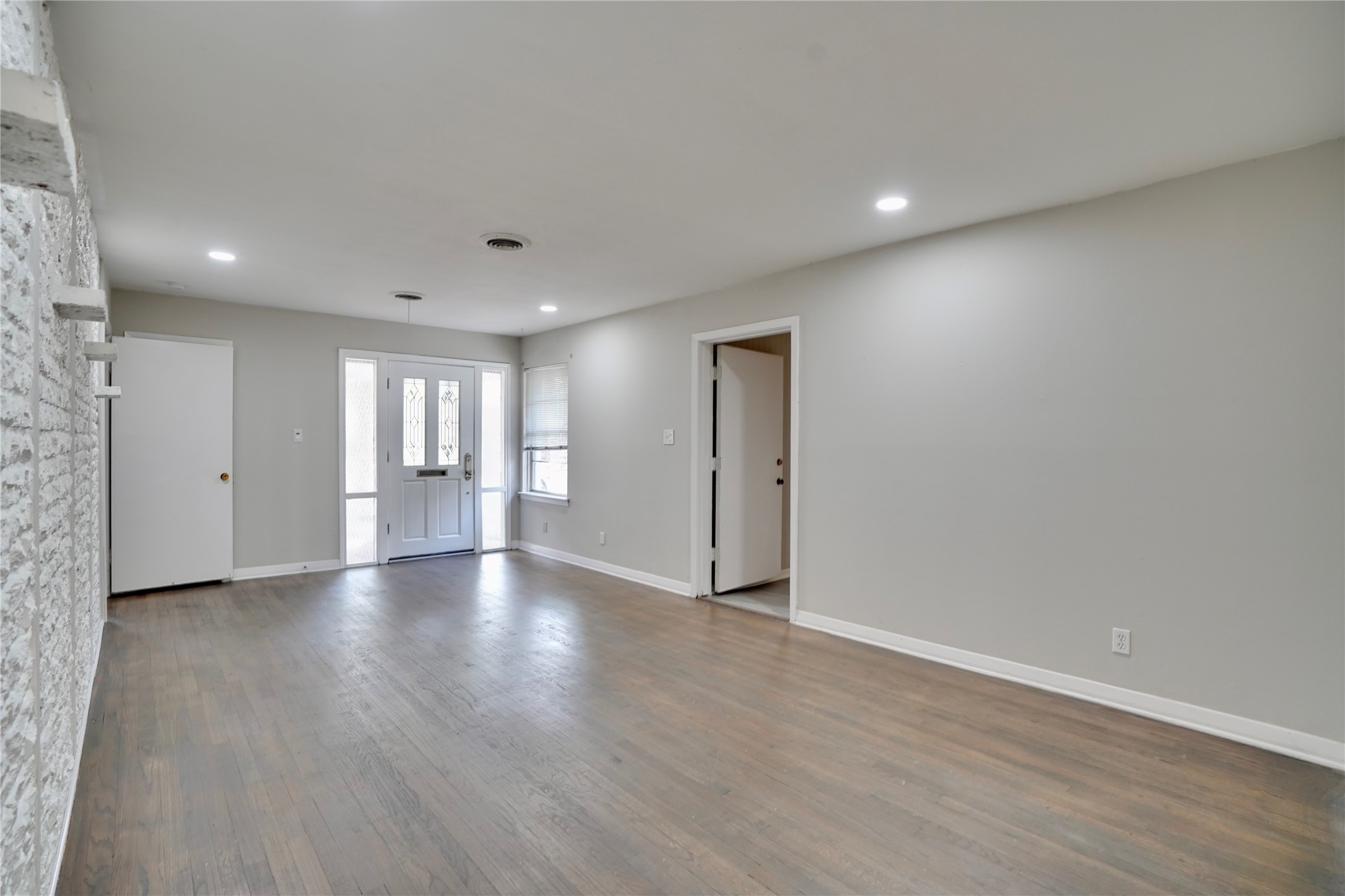 4550 Spellman Road Houston, TX 77035 - Photo 23 of 27 a view of an empty room with wooden floor and windows