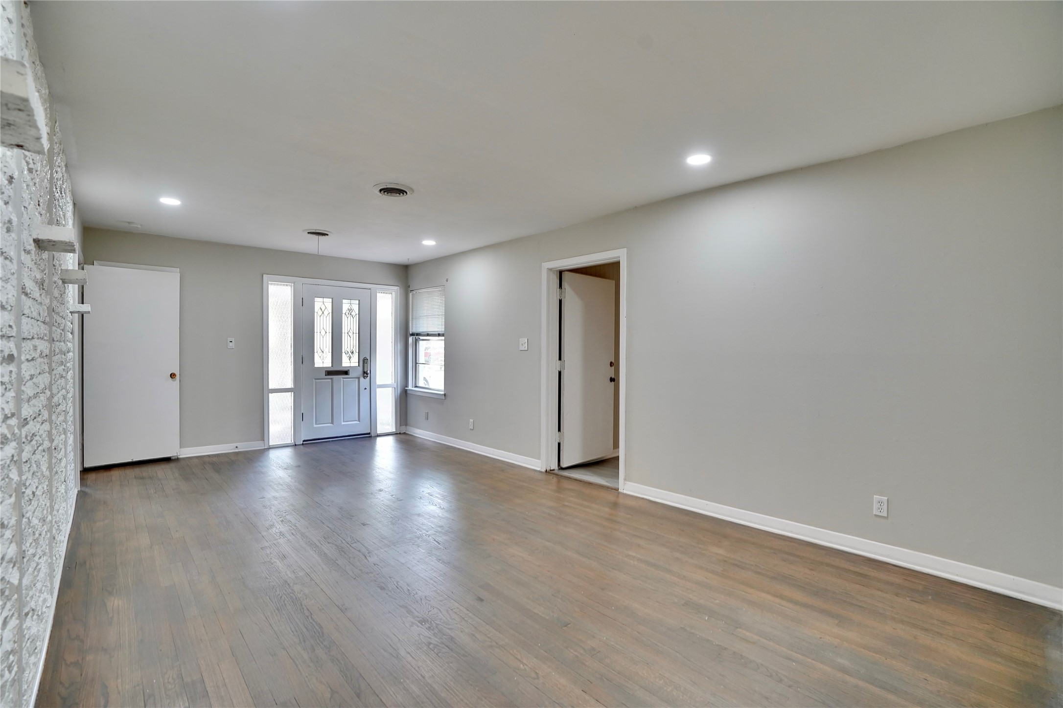 4550 Spellman Road Houston, TX 77035 - Photo 24 of 27 a view of an empty room with wooden floor and windows