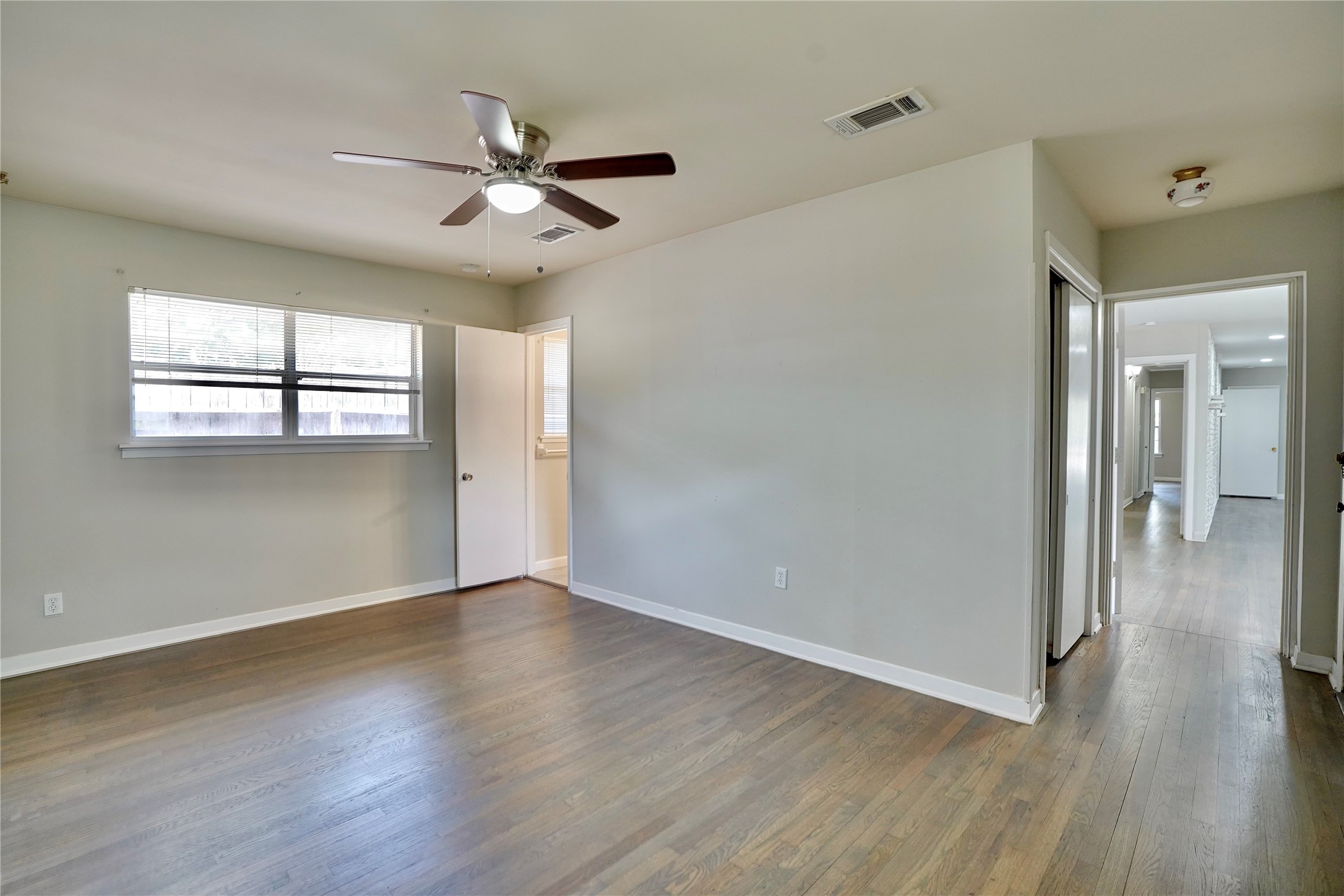 4550 Spellman Road Houston, TX 77035 - Photo 9 of 27 wooden floor in an empty room with a window