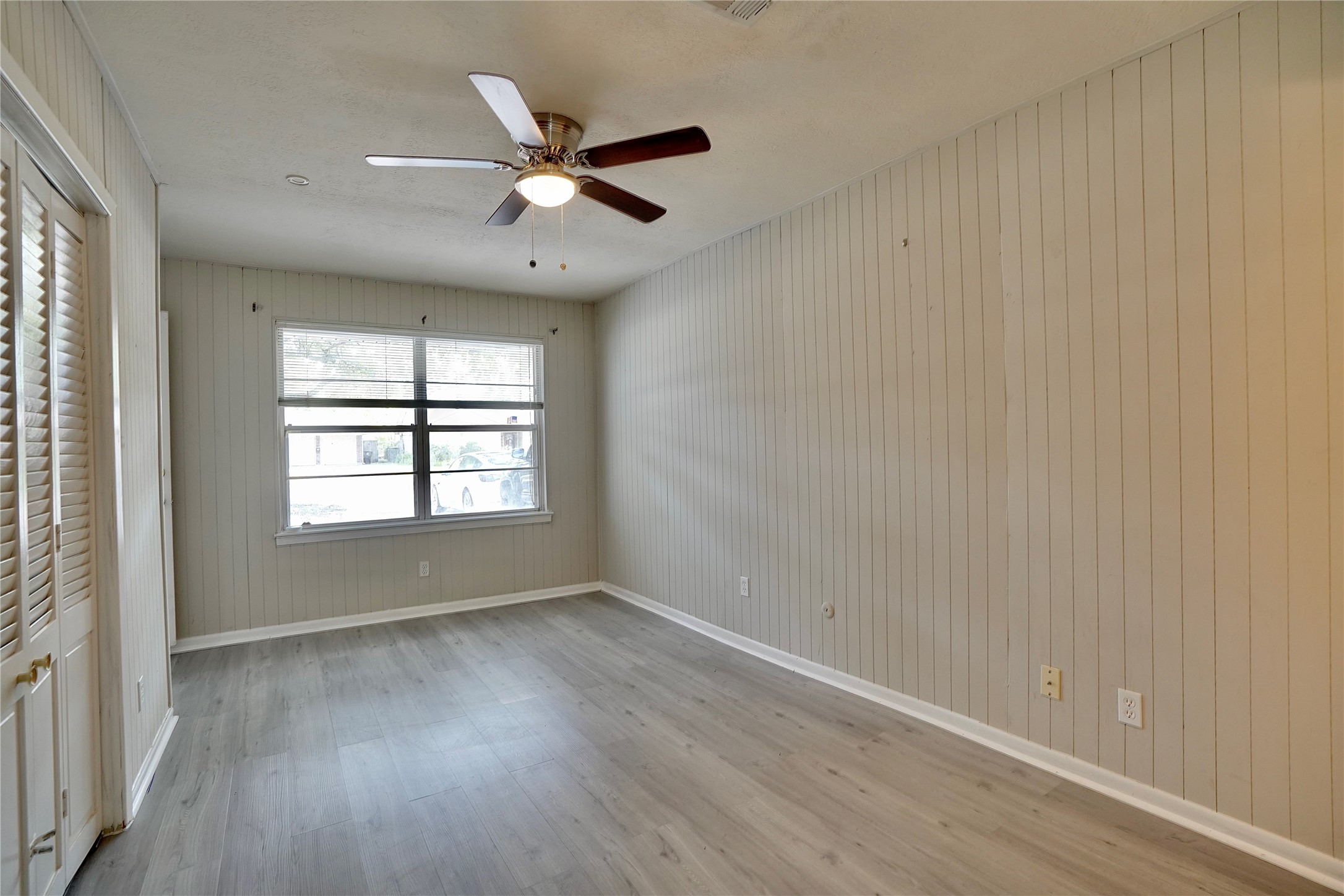 4550 Spellman Road Houston, TX 77035 - Photo 10 of 27 an empty room with wooden floor fan and windows