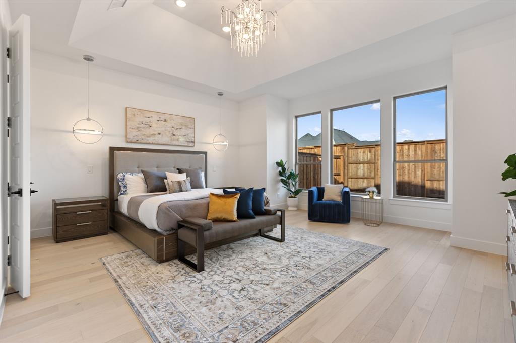 270 Peach Pt Road Prosper, TX 75078 - Photo 19 of 40 a bedroom with a large bed and a couch