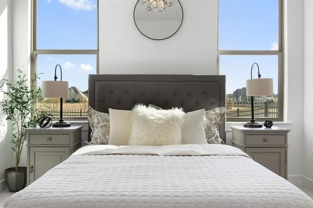 a bedroom with a bed and a chandelier