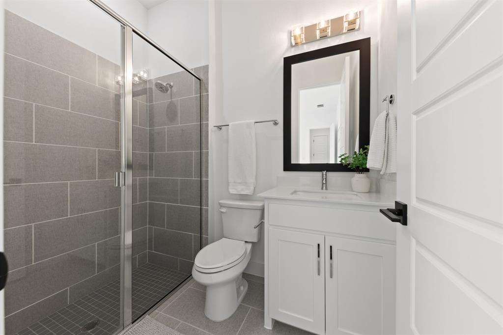 270 Peach Pt Road Prosper, TX 75078 - Photo 26 of 40 a bathroom with a toilet sink and shower