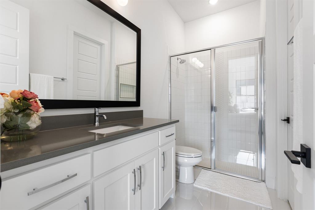 270 Peach Pt Road Prosper, TX 75078 - Photo 29 of 40 a bathroom with a double vanity sink toilet and shower