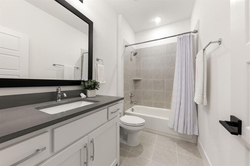 270 Peach Pt Road Prosper, TX 75078 - Photo 32 of 40 a bathroom with a bathtub shower sink vanity and toilet