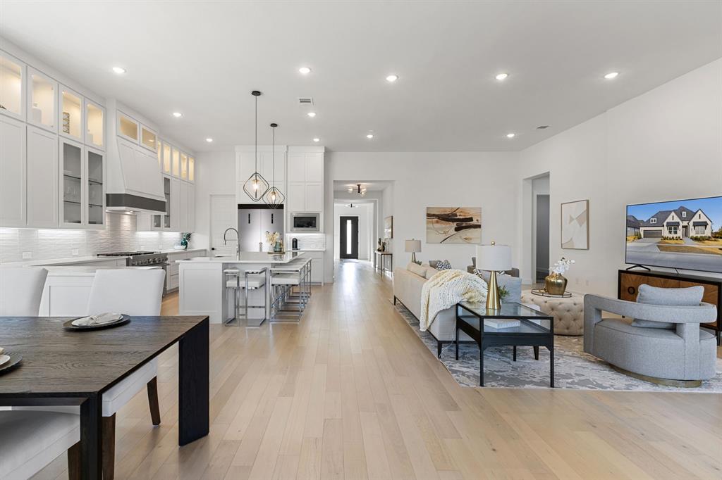 270 Peach Pt Road Prosper, TX 75078 - Photo 10 of 40 a living room with furniture and a dining table with kitchen view