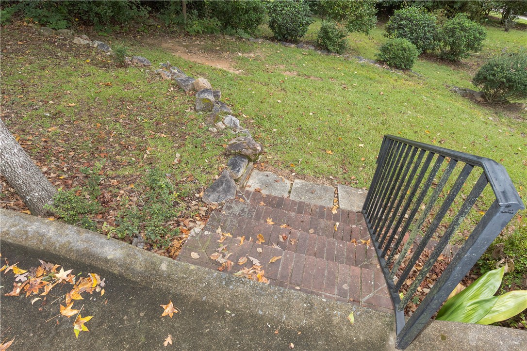 118 Blair Road Belton, SC 29627 - Photo 43 of 49 Brick steps with a secure metal handrail lead down to a grassy yard.