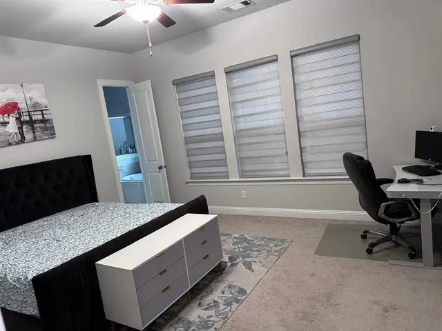 a bedroom with a bed and a desk