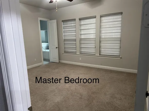 a bathroom with a toilet and a shower curtain
