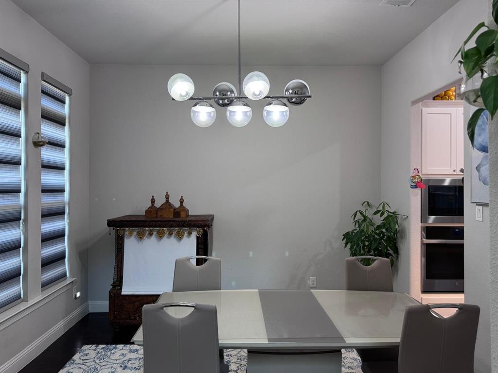 3567 Sevilla Drive Frisco, TX 75034 - Photo 6 of 27 a view of a dining room with furniture and chandelier