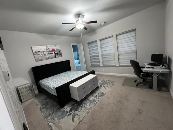 a bedroom with furniture and a chandelier