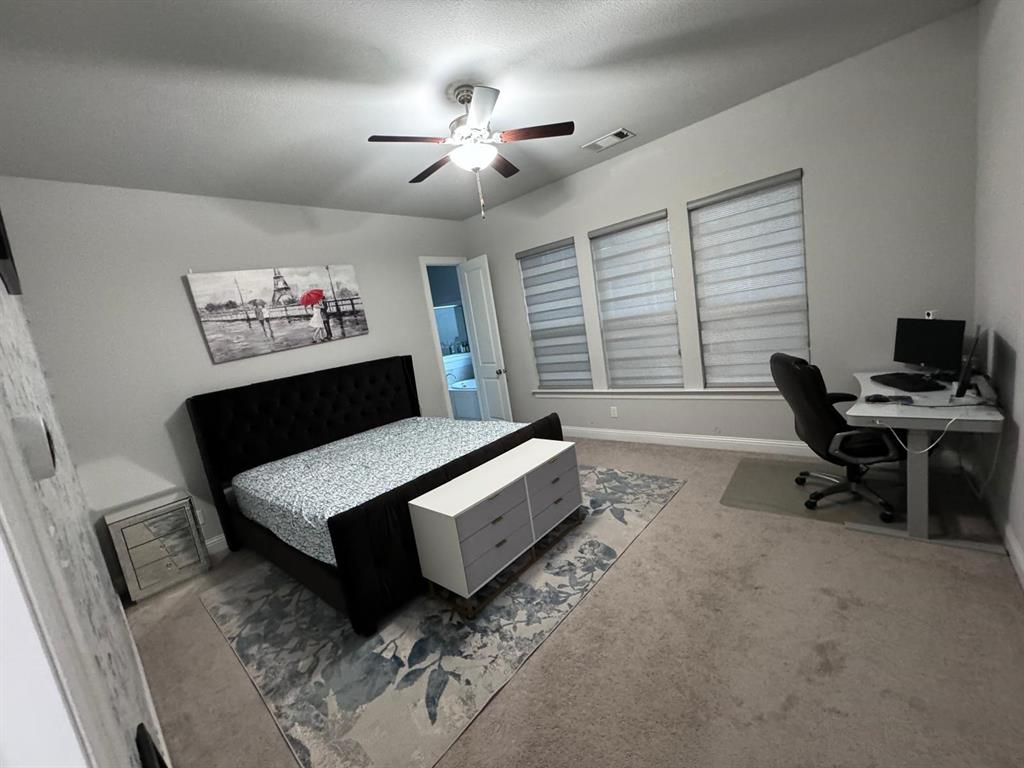 3567 Sevilla Drive Frisco, TX 75034 - Photo 7 of 27 a bedroom with furniture and a chandelier