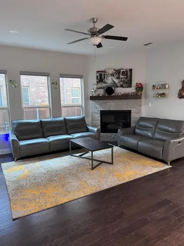a living room with furniture and a fireplace