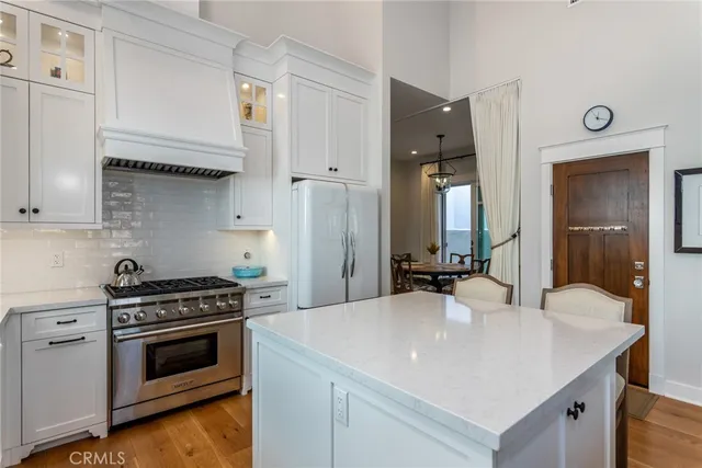 a kitchen with stainless steel appliances a sink stove and cabinets