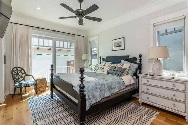 a large bedroom with a bed and wooden floor