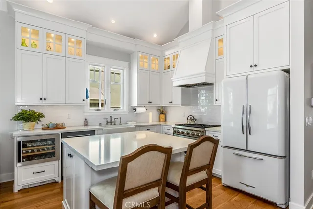 a kitchen with a refrigerator a sink and cabinets