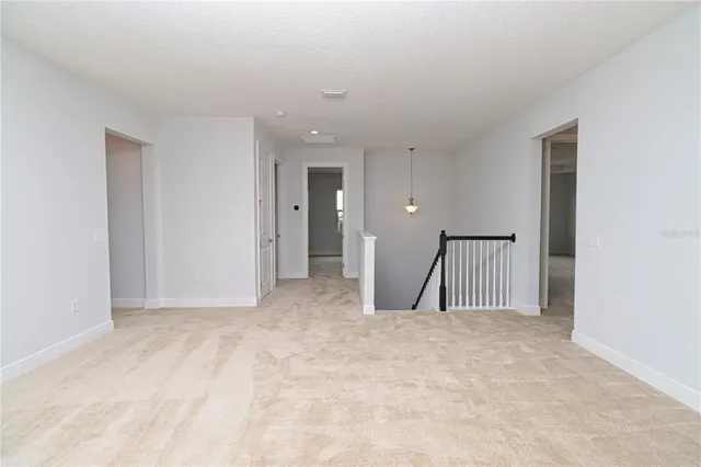 a view of an empty room with windows