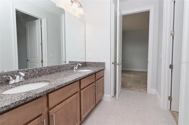 an empty room with closet and a bathroom