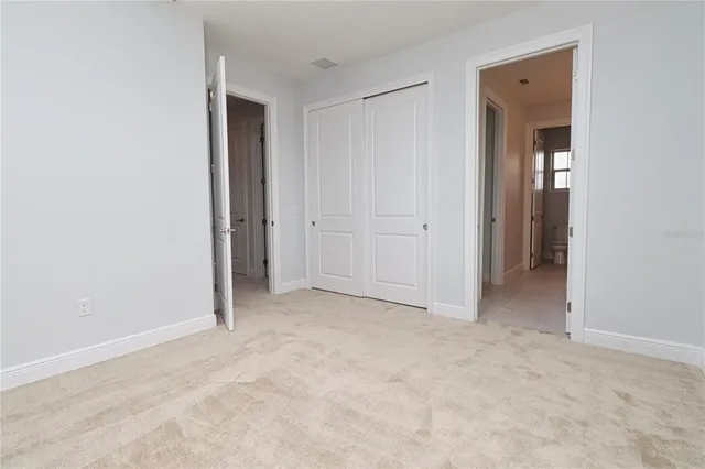 a large white kitchen with stainless steel appliances granite countertop a stove a sink a microwave and cabinets