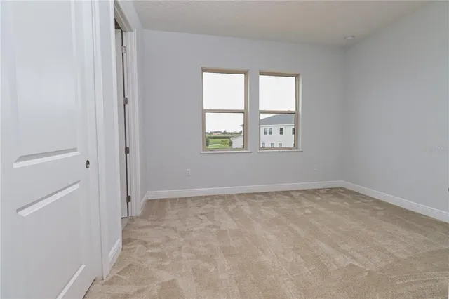 a kitchen with stainless steel appliances granite countertop a sink a window and a counter top space