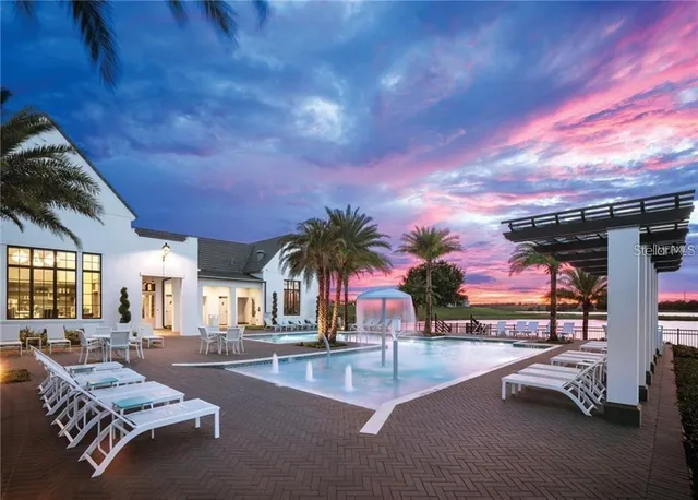 a backyard of a house with table and chairs